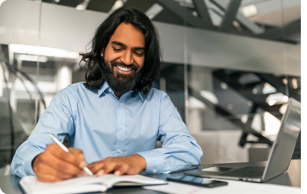 Smiling professional taking notes at desk